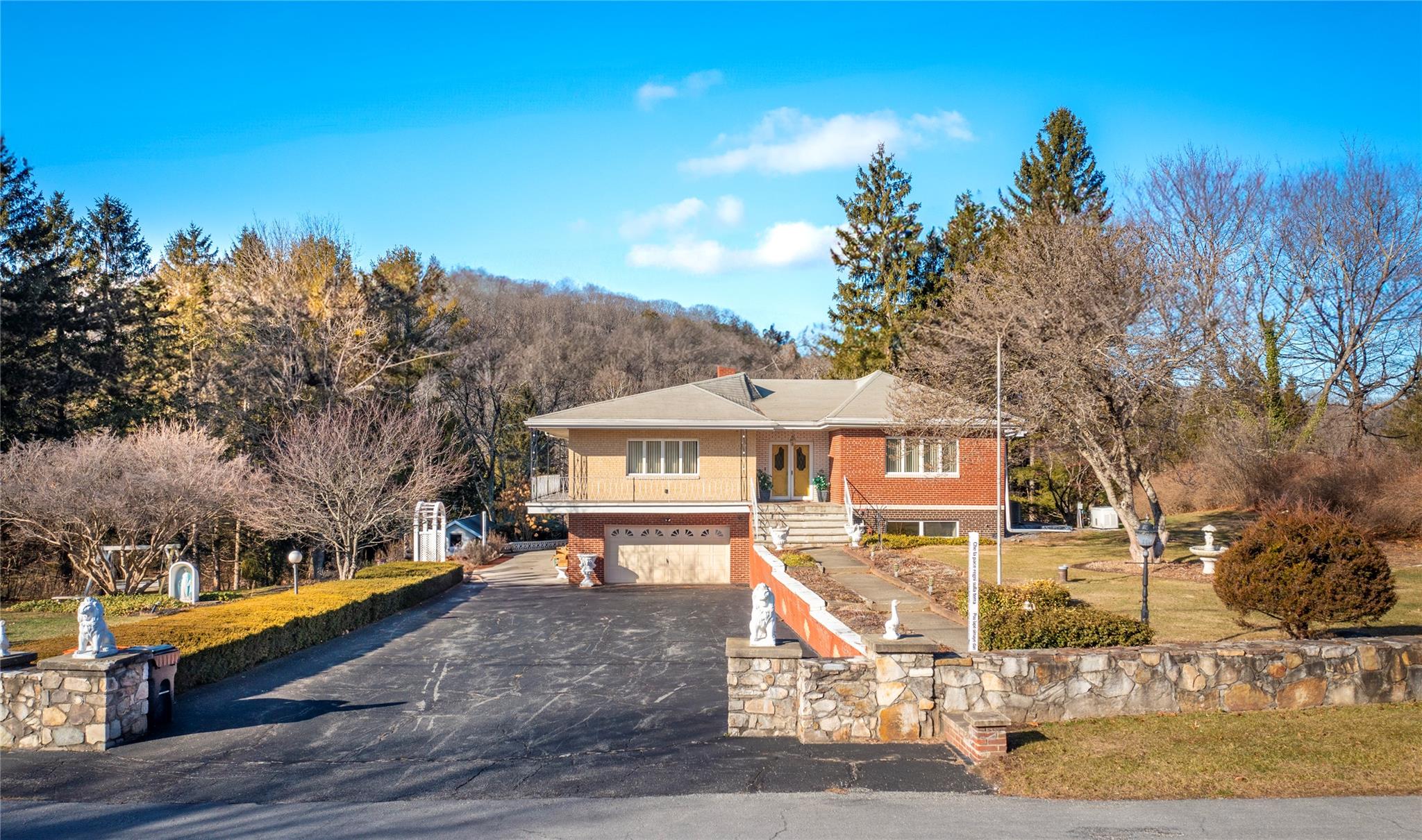 View of front of property featuring a garage and a front yard