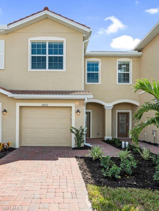 a front view of a house with a yard and garage