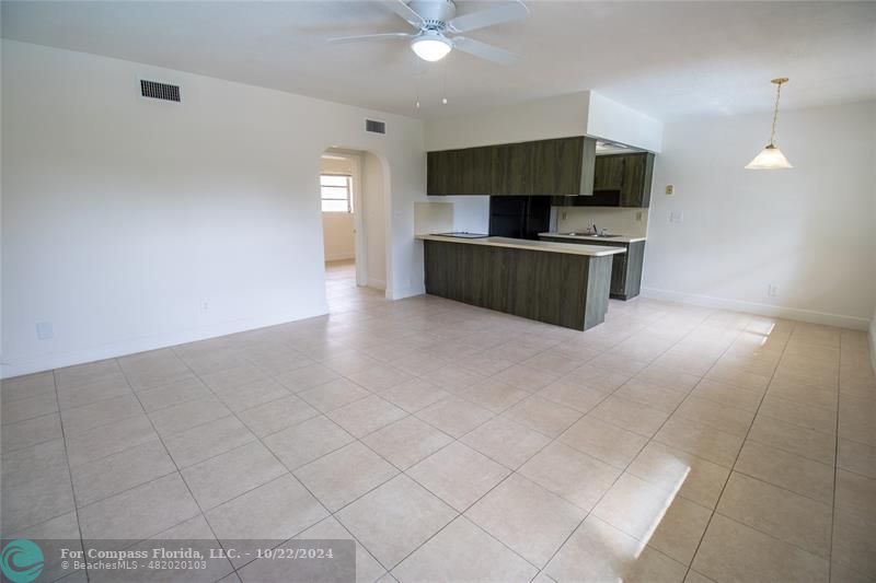 a view of kitchen with microwave and cabinets