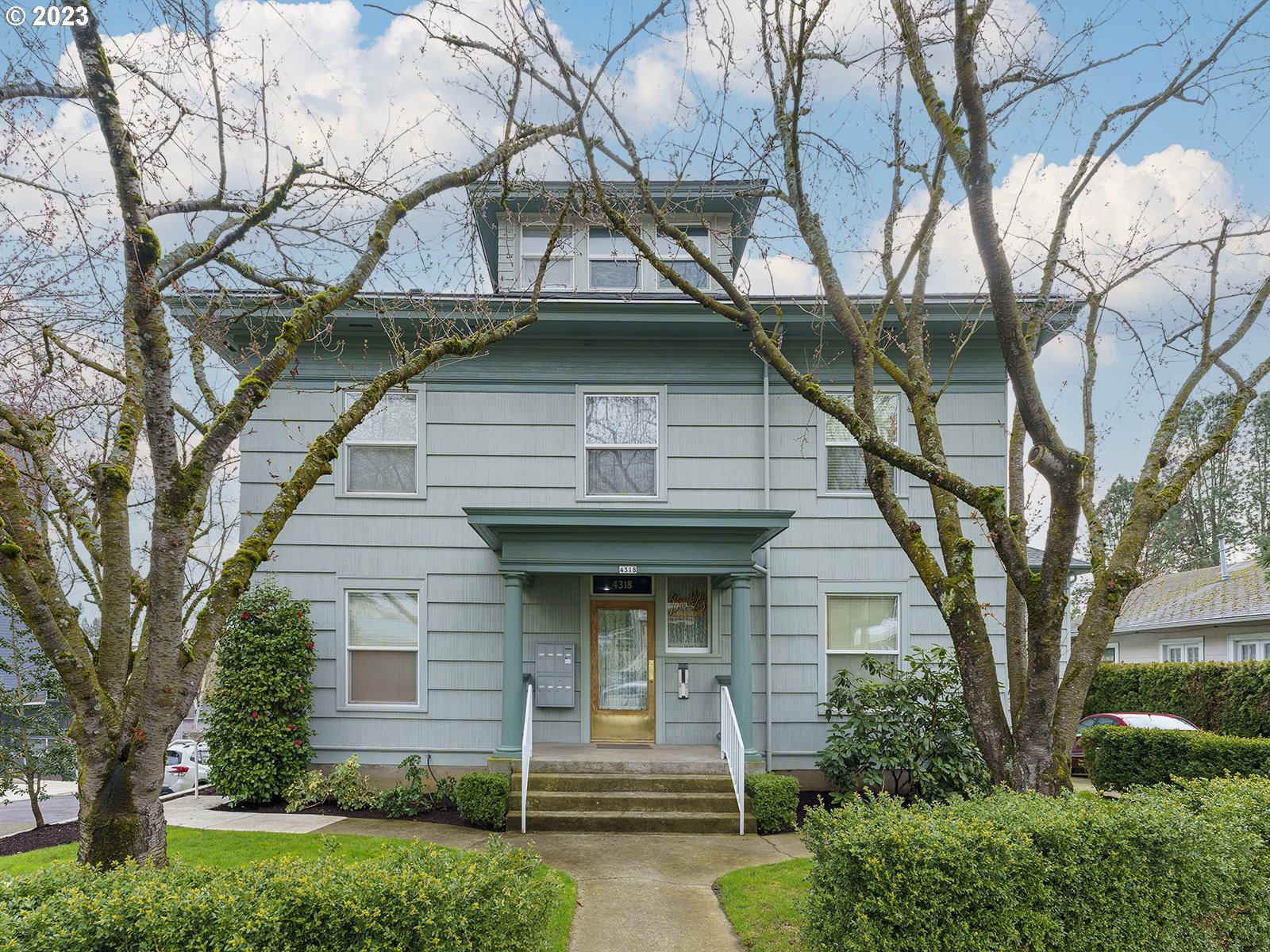 a front view of a house with garden