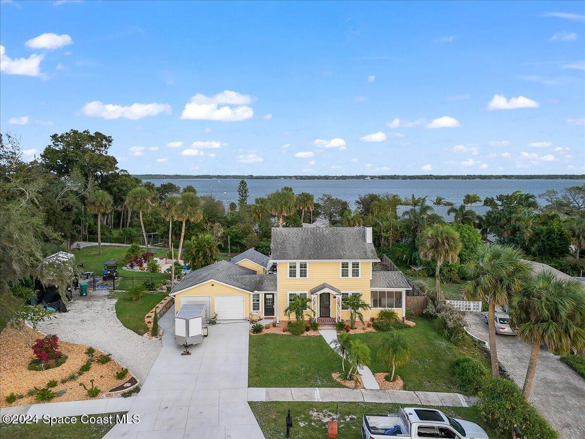 an aerial view of a house with garden space and street view