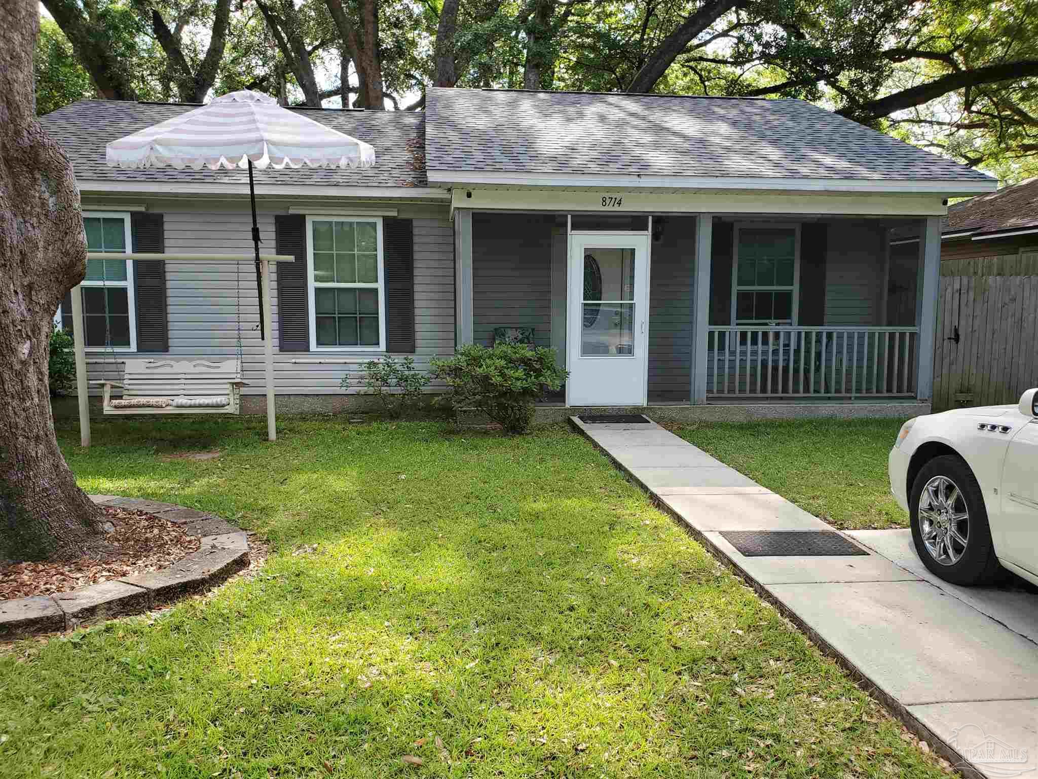 a view of a house with a yard and porch