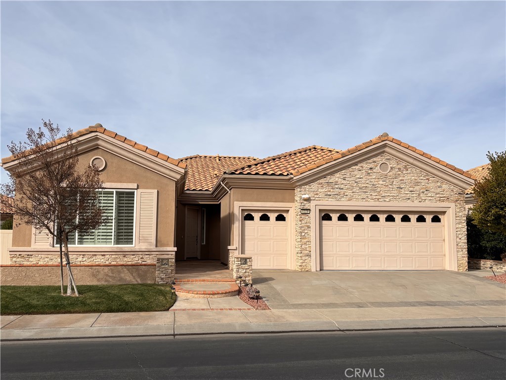 a front view of a house with garage and parking