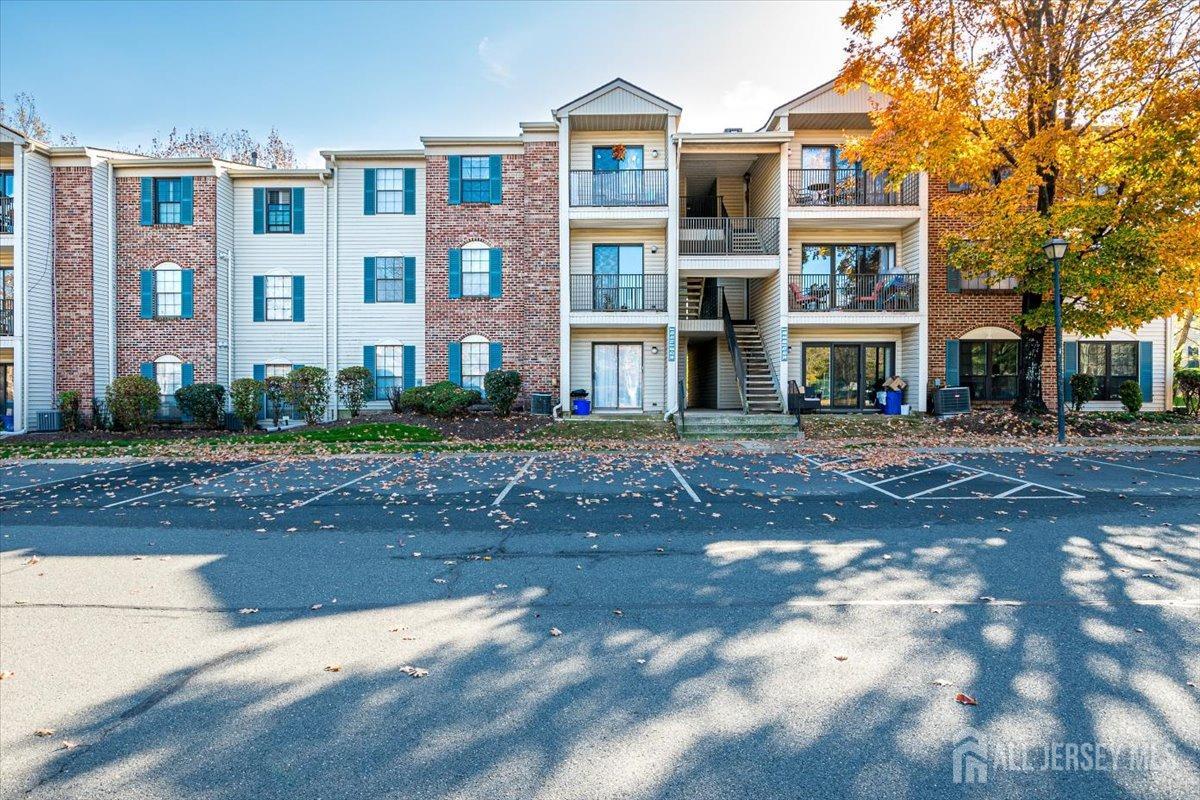 a front view of a residential apartment building with a yard