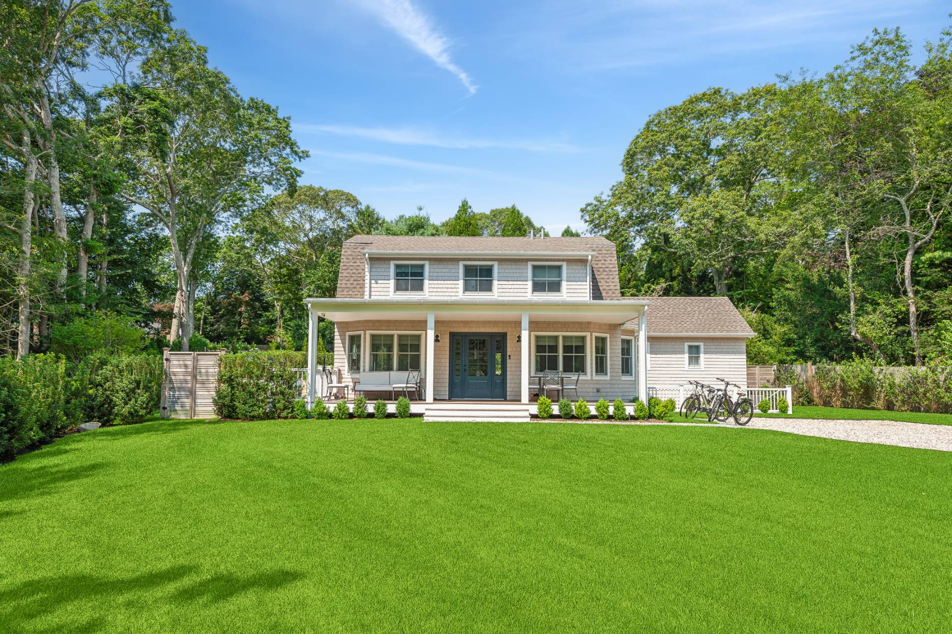 a front view of a house with a garden