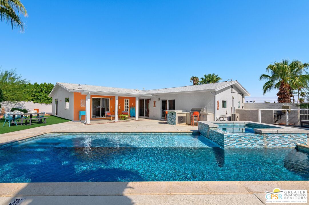 a front view of house with yard and outdoor seating