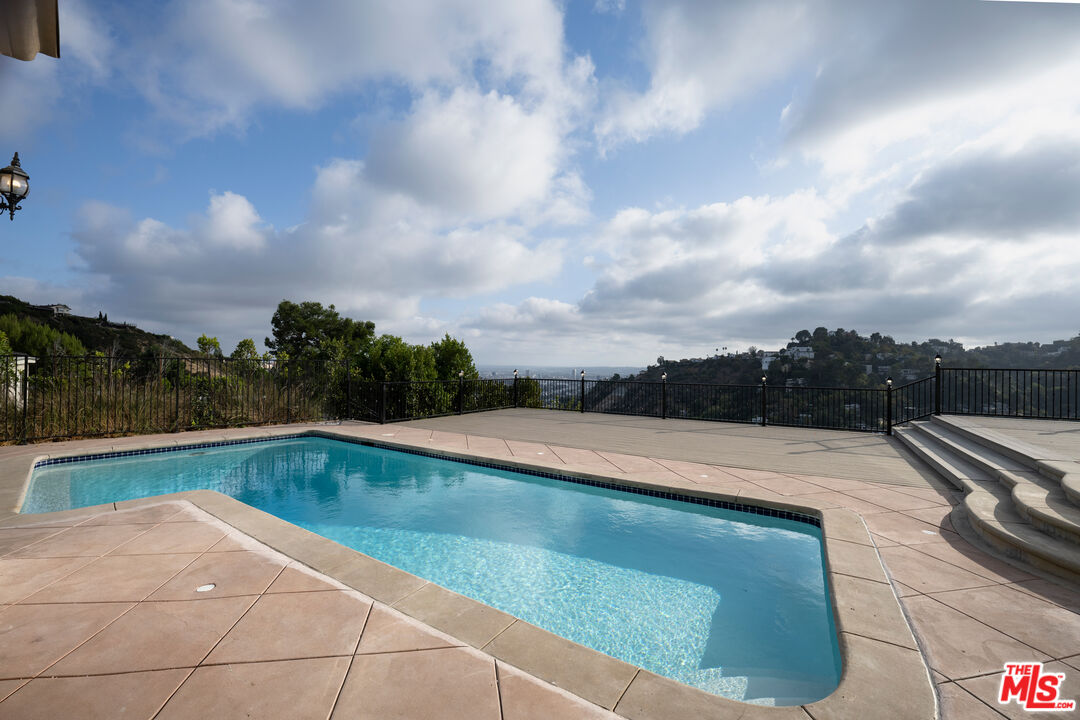 a view of swimming pool with a yard