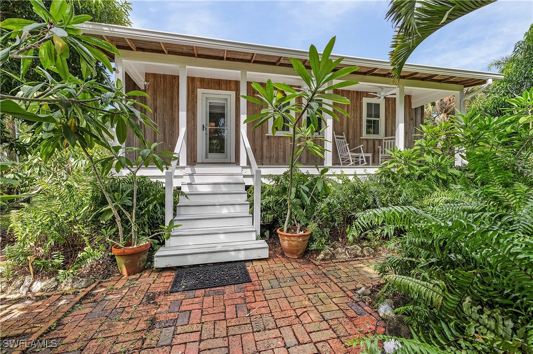 a front view of a house with plants