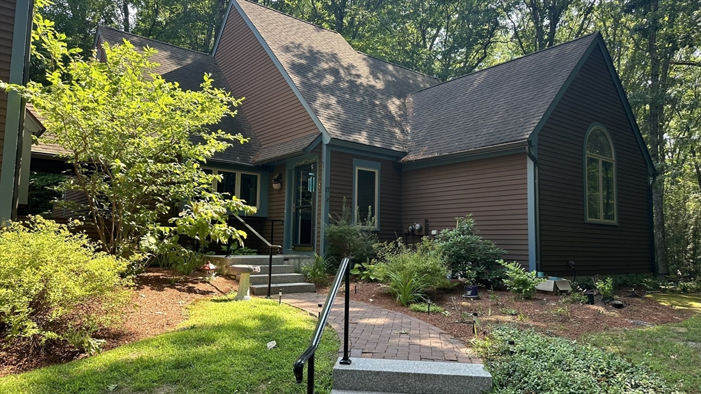 a view of a house with a yard and plants