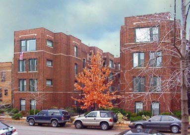 a front view of a building with parking space