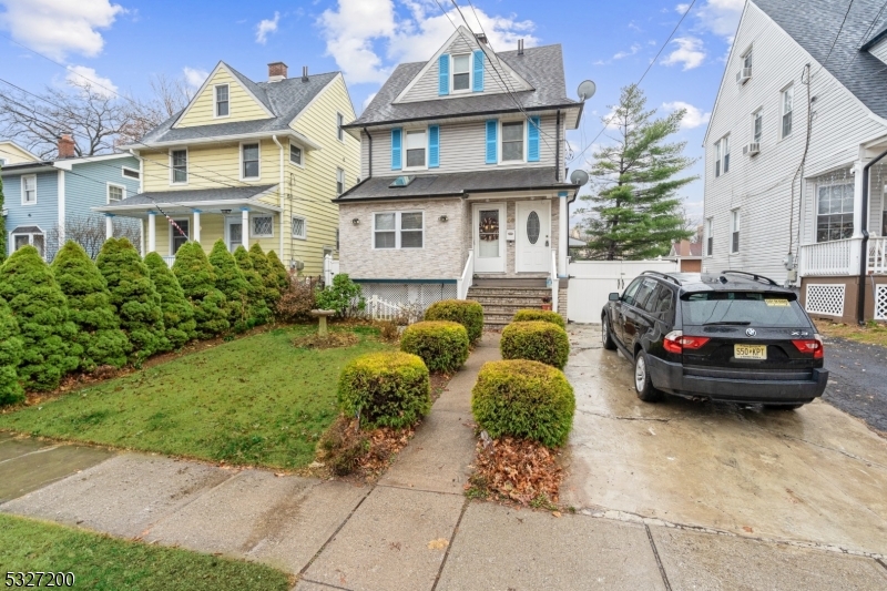 a car parked in front of a brick house