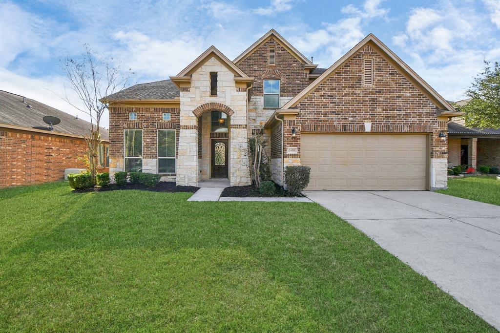 a front view of a house with a yard and garage