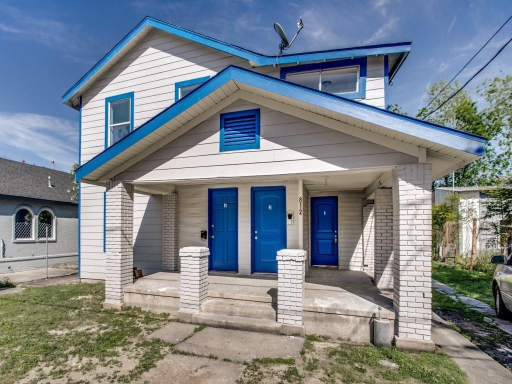 a view of a house with entrance stairs and a yard