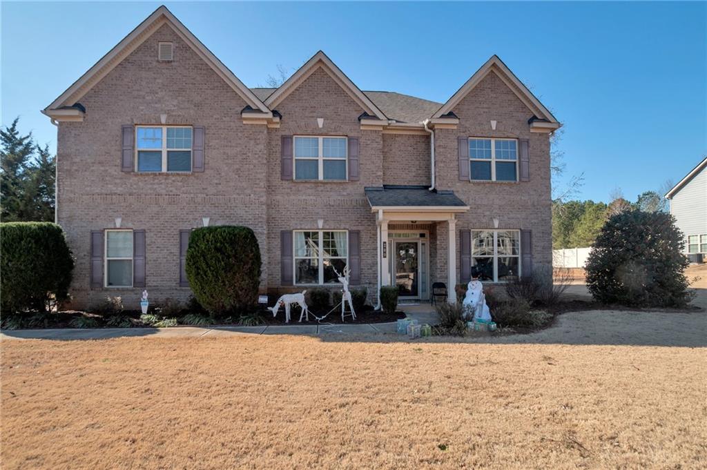 a front view of a house with a yard