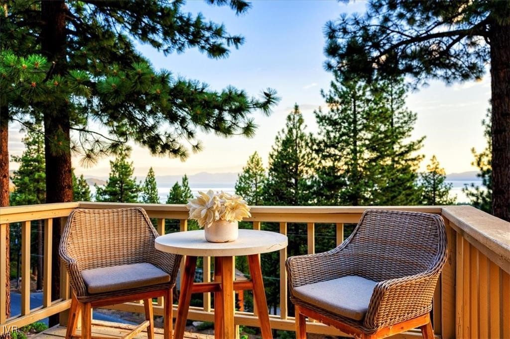 a view of a patio with table and chairs and wooden fence