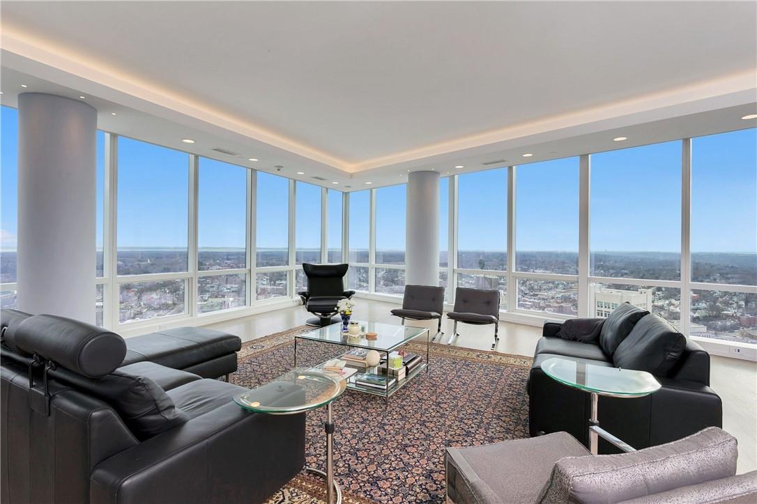 a living room with furniture and large windows