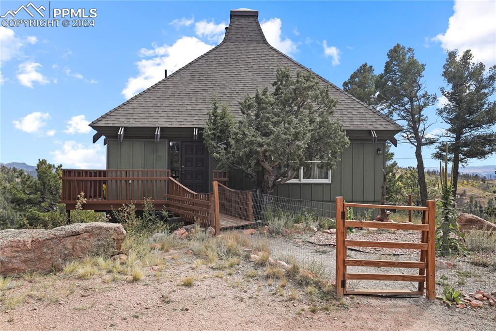 a backyard of a house with wooden floor and fence