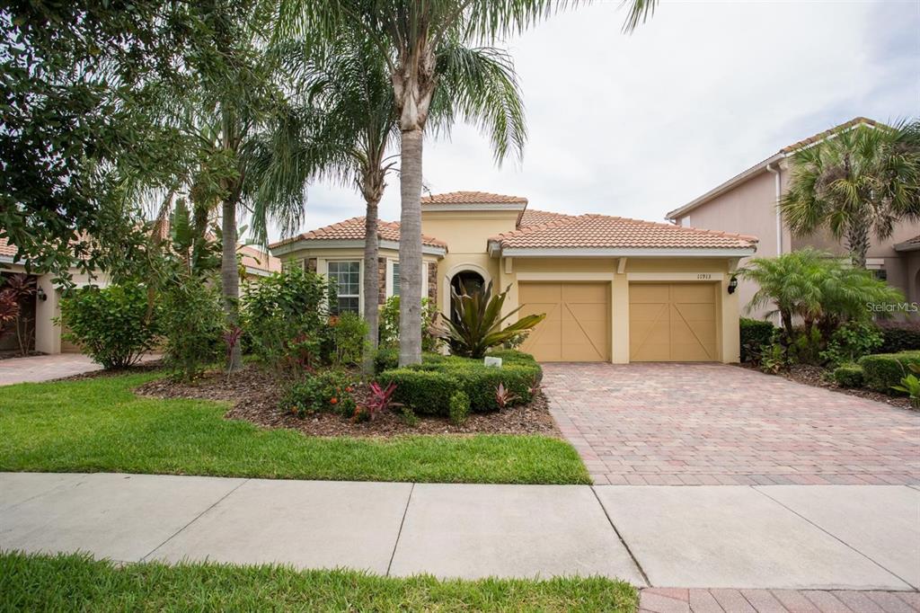 a front view of a house with a garden