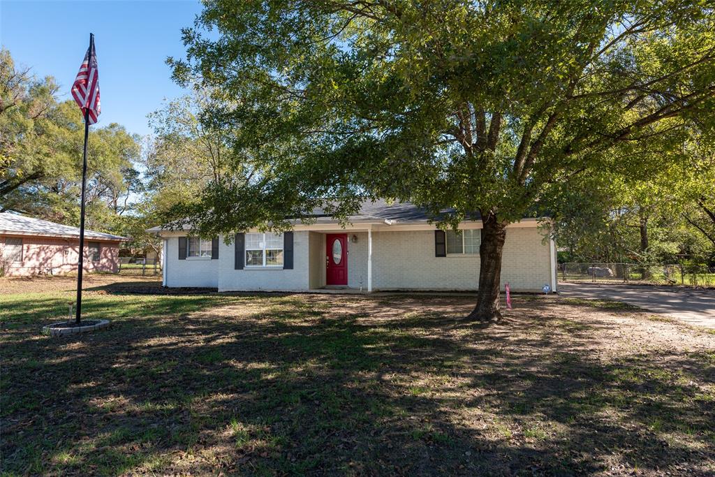 a house that has a tree in front of it