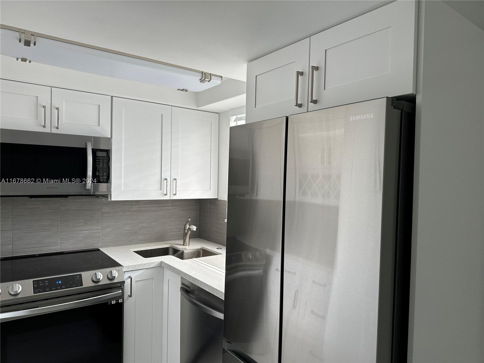 a kitchen with a refrigerator stove and microwave