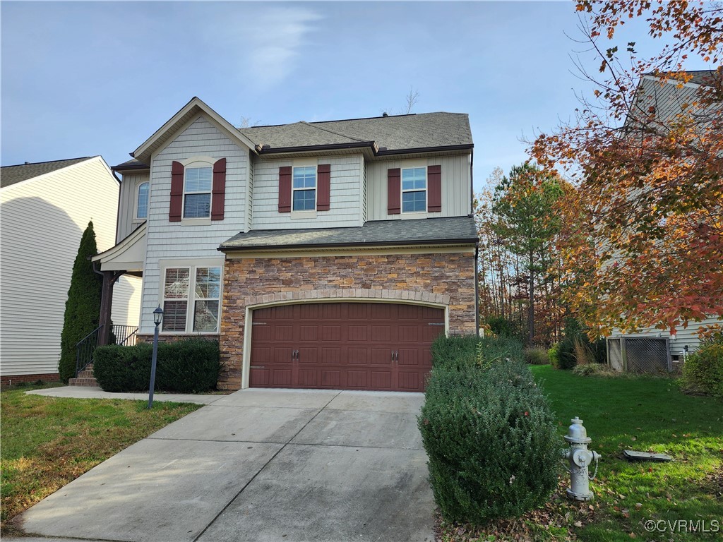 Front of property with a front yard and a garage