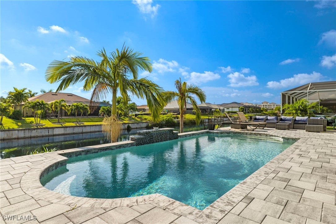 a view of swimming pool with outdoor seating and plants