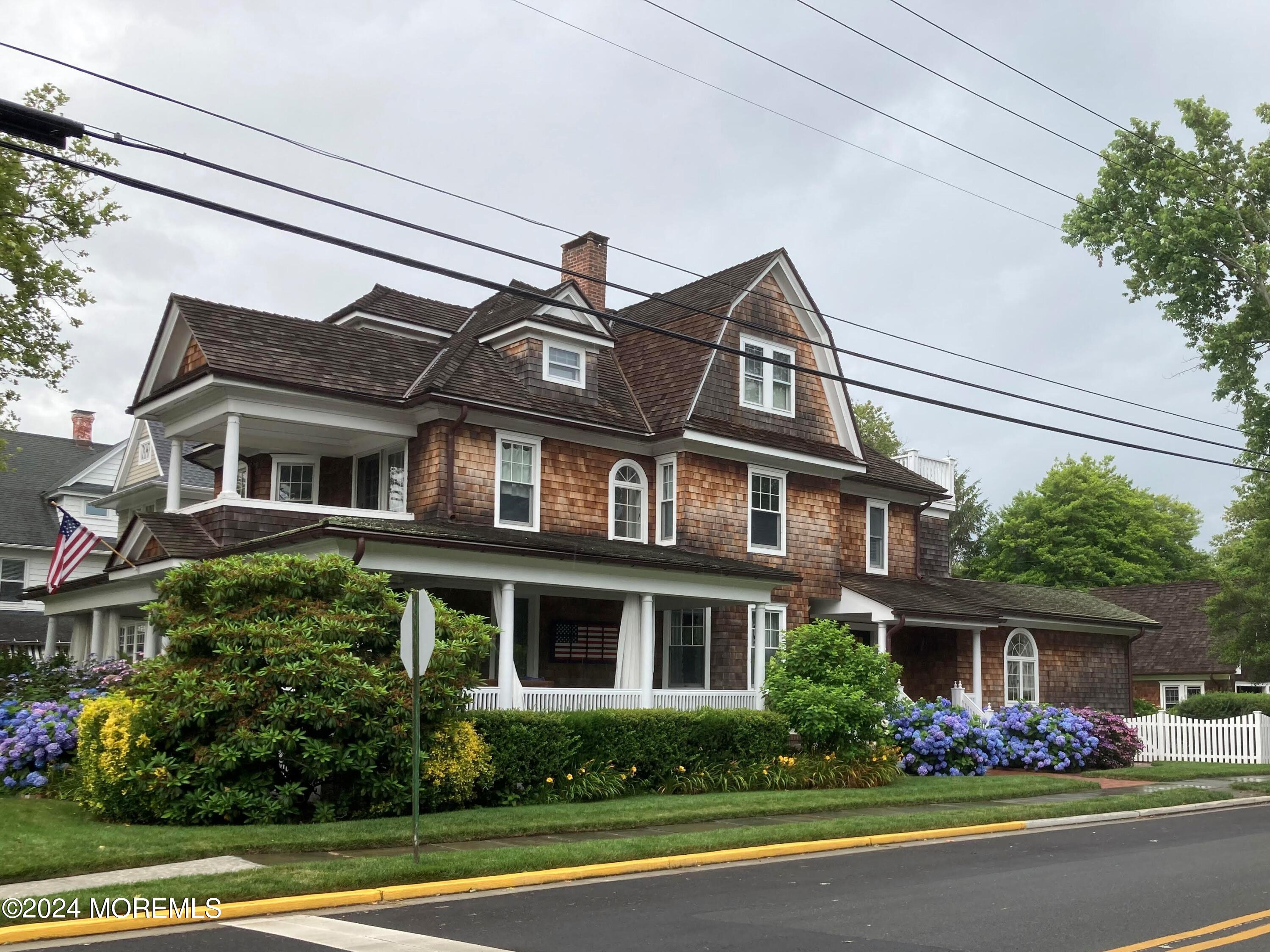 a front view of house with trees in the background