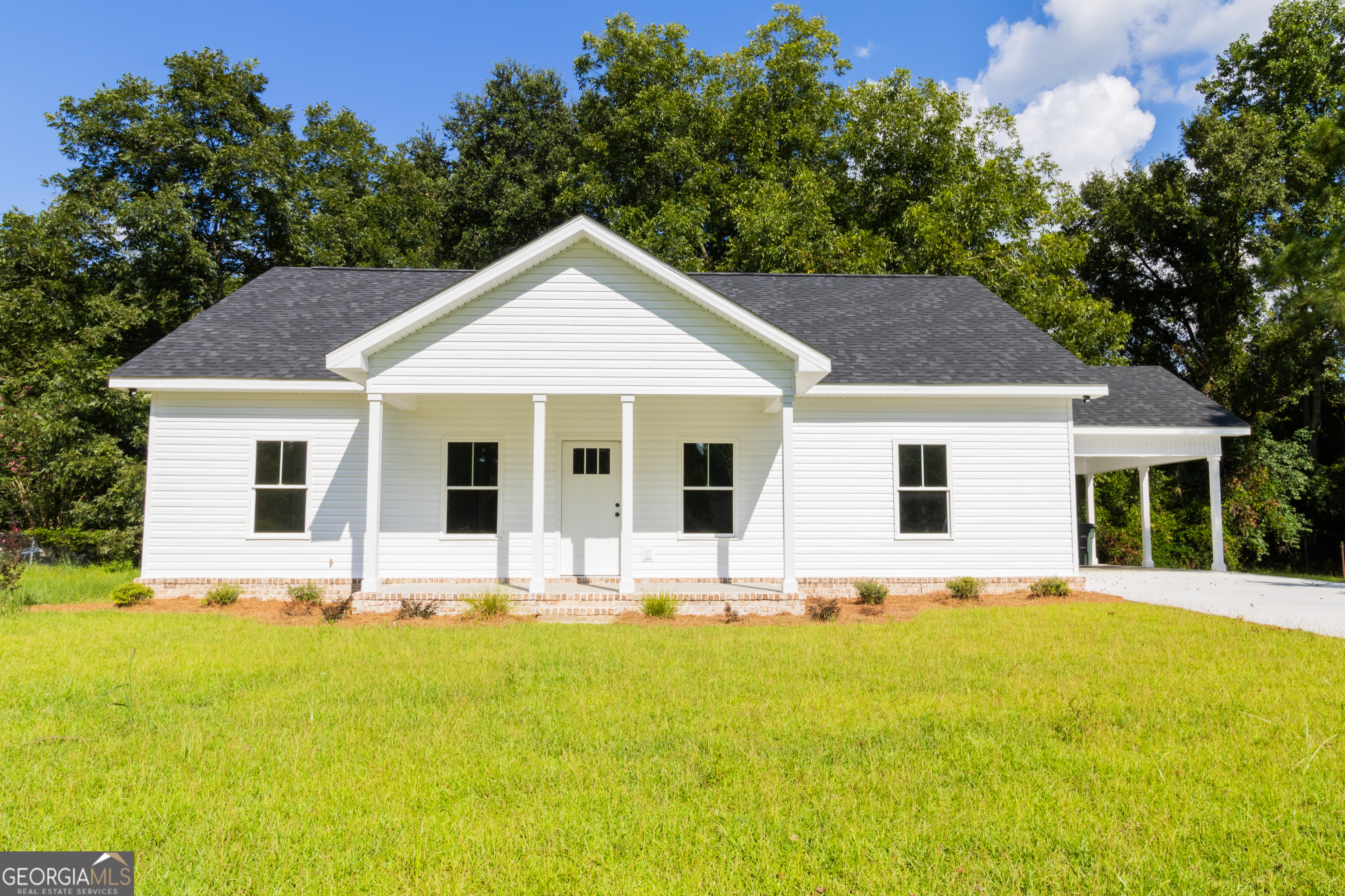 a front view of house with yard outdoor seating and green space