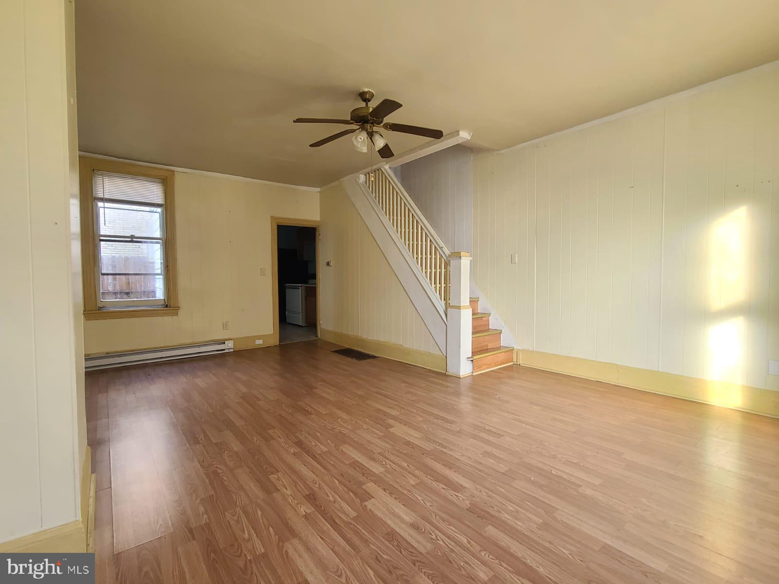 wooden floor in an empty room with a window