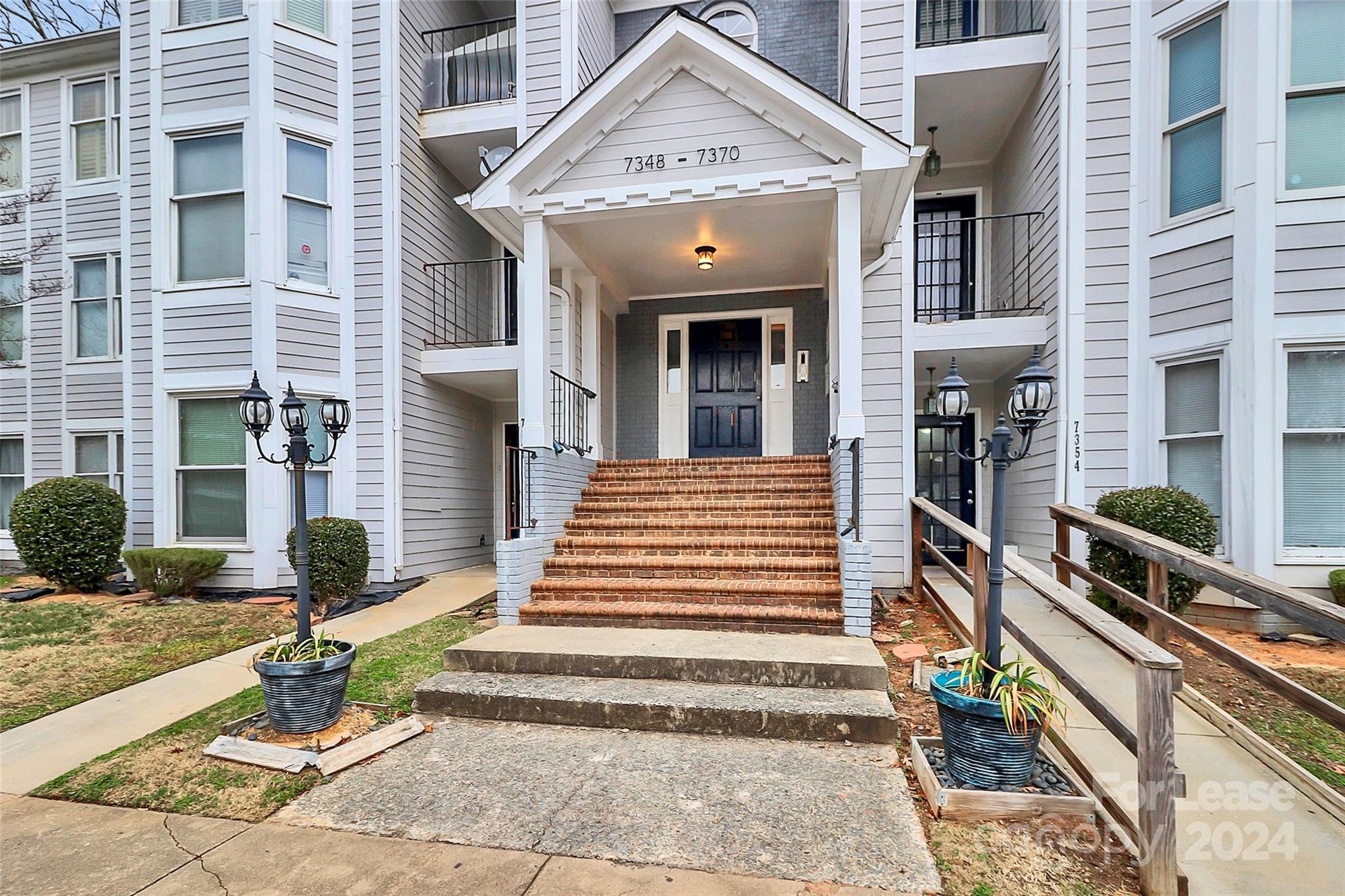 a front view of a house with stairs