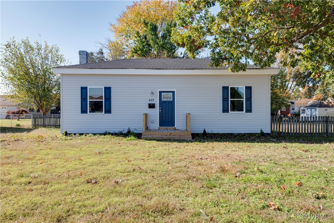 a backyard of a house with yard and tree