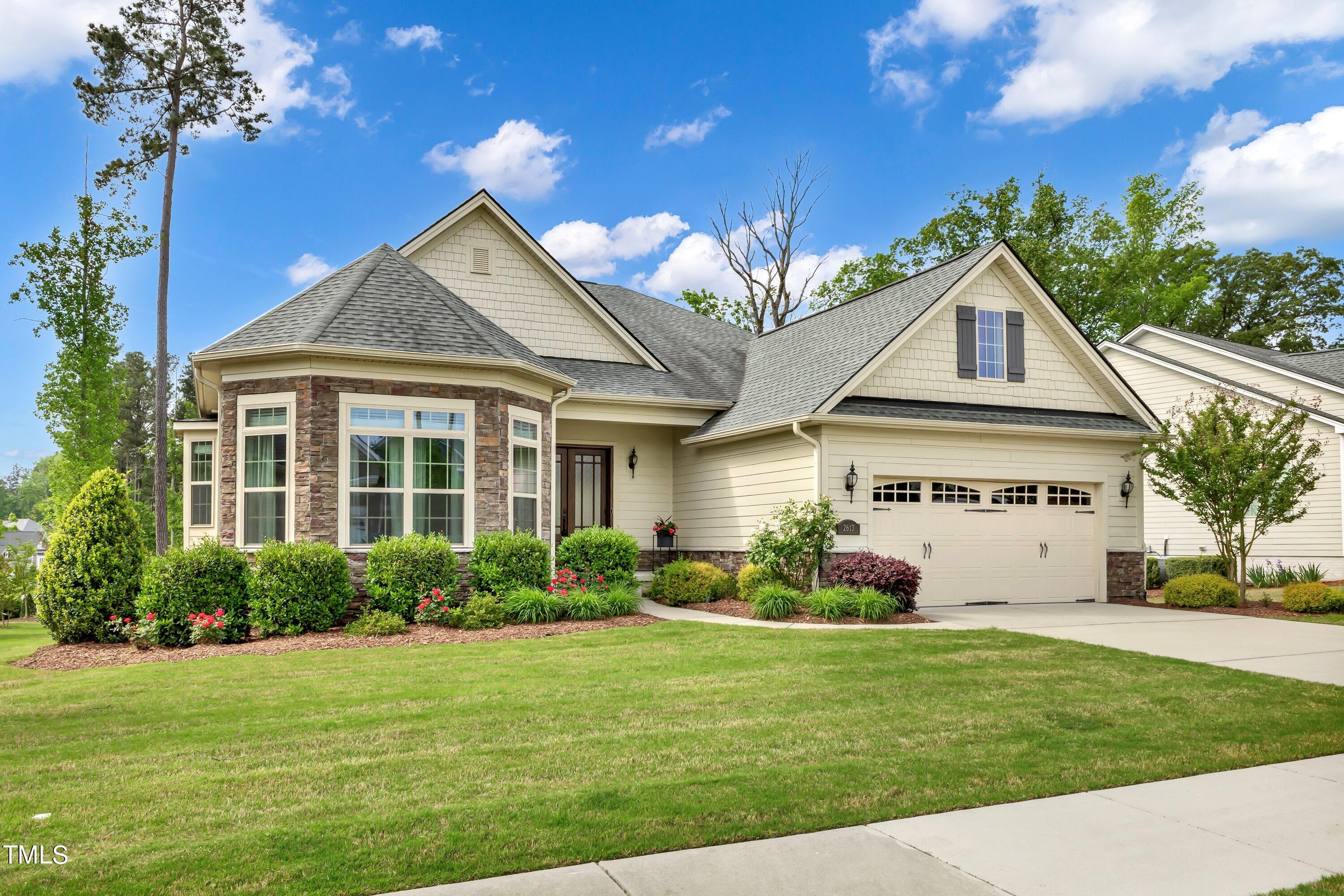 a front view of a house with garden