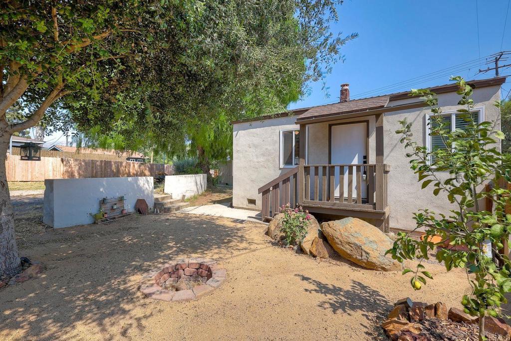 a view of a house with a tree in the background