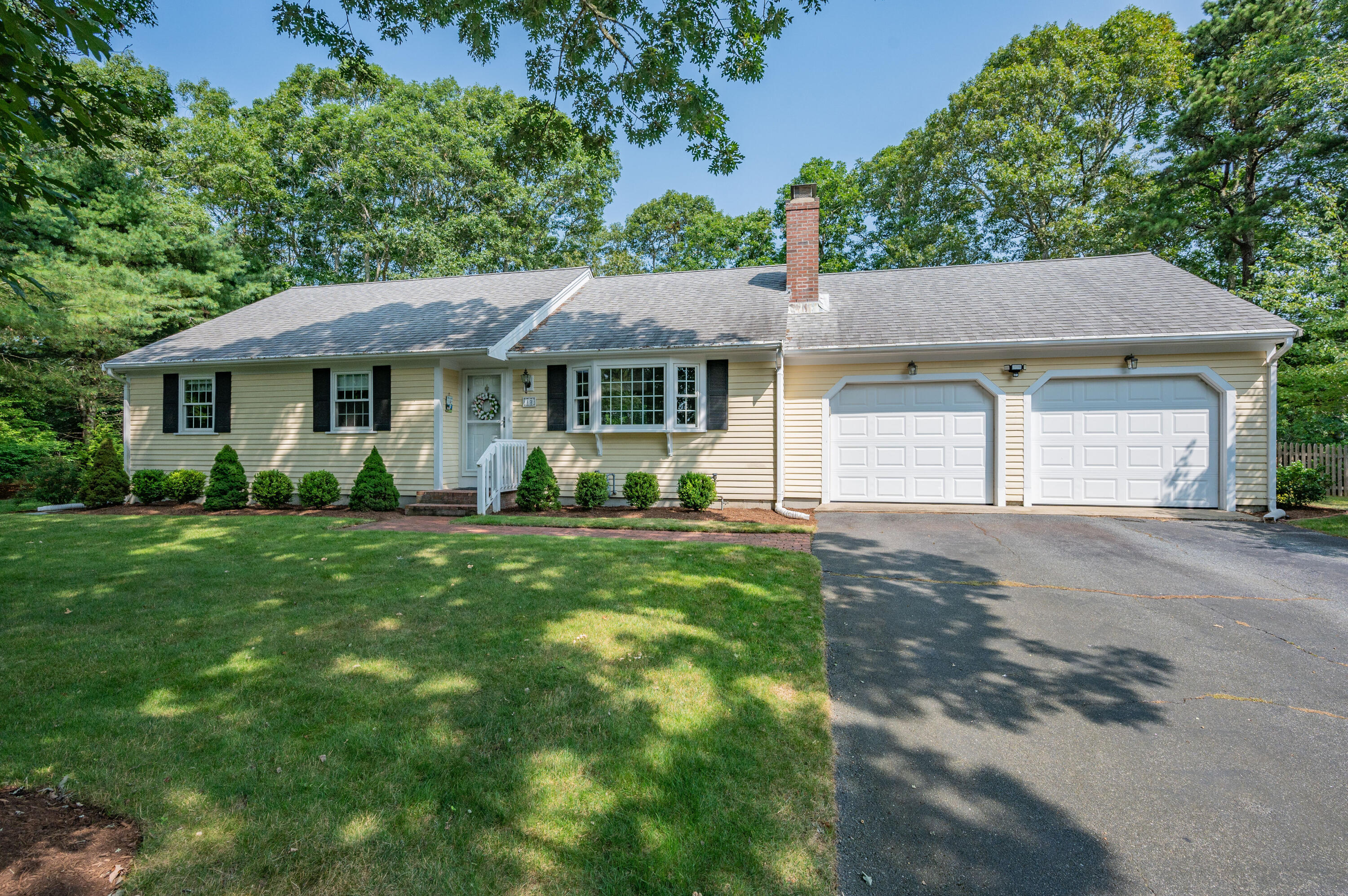 a view of a house with yard and a garden