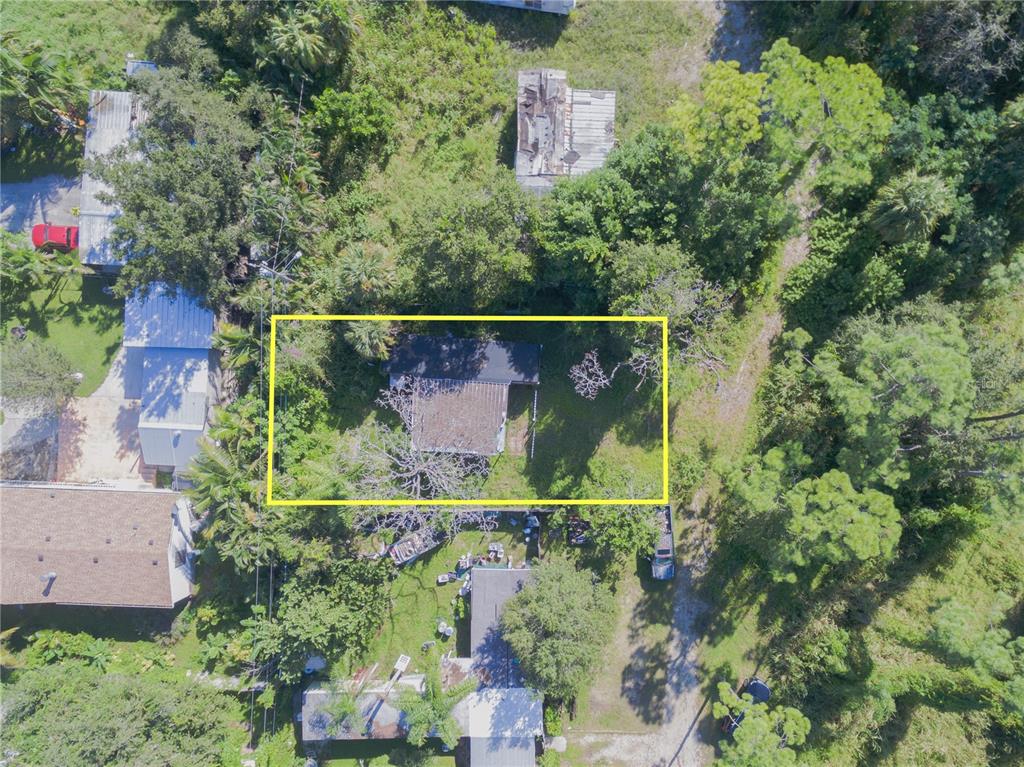 an aerial view of a house with a yard and garden