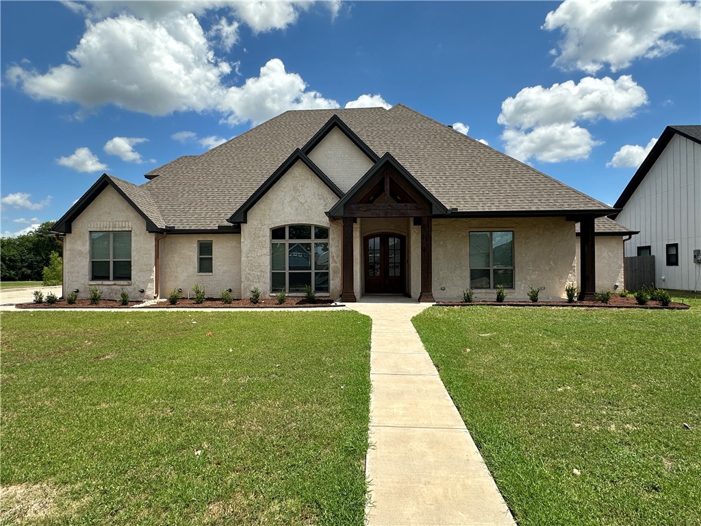 a front view of a house with a garden and porch