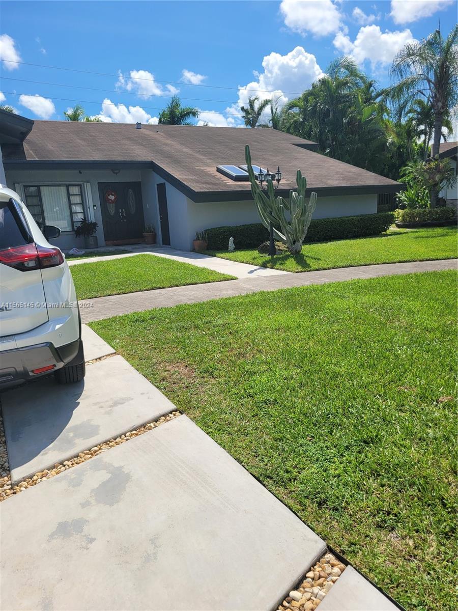 a view of a house with a back yard