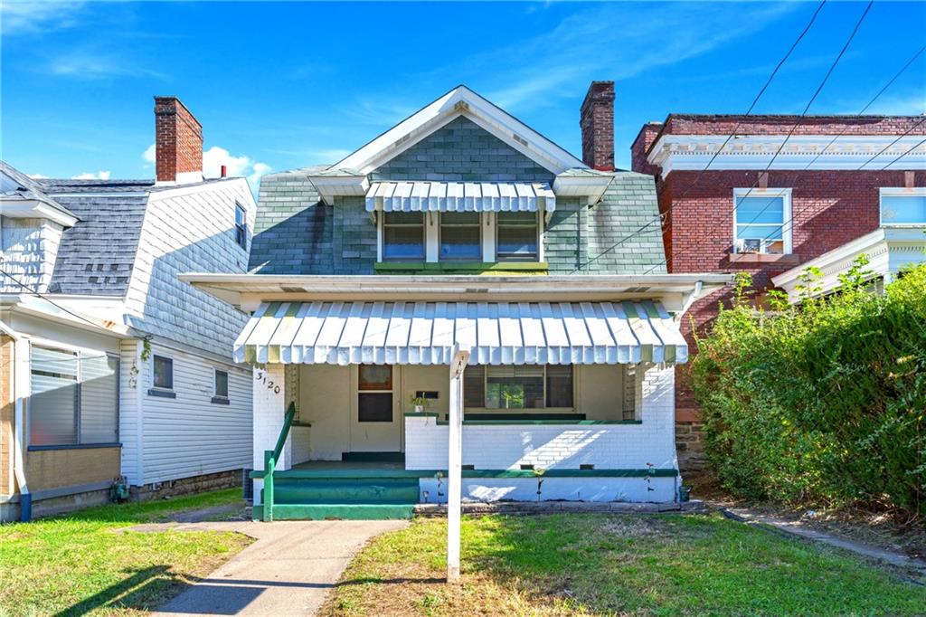 a front view of a house with a yard