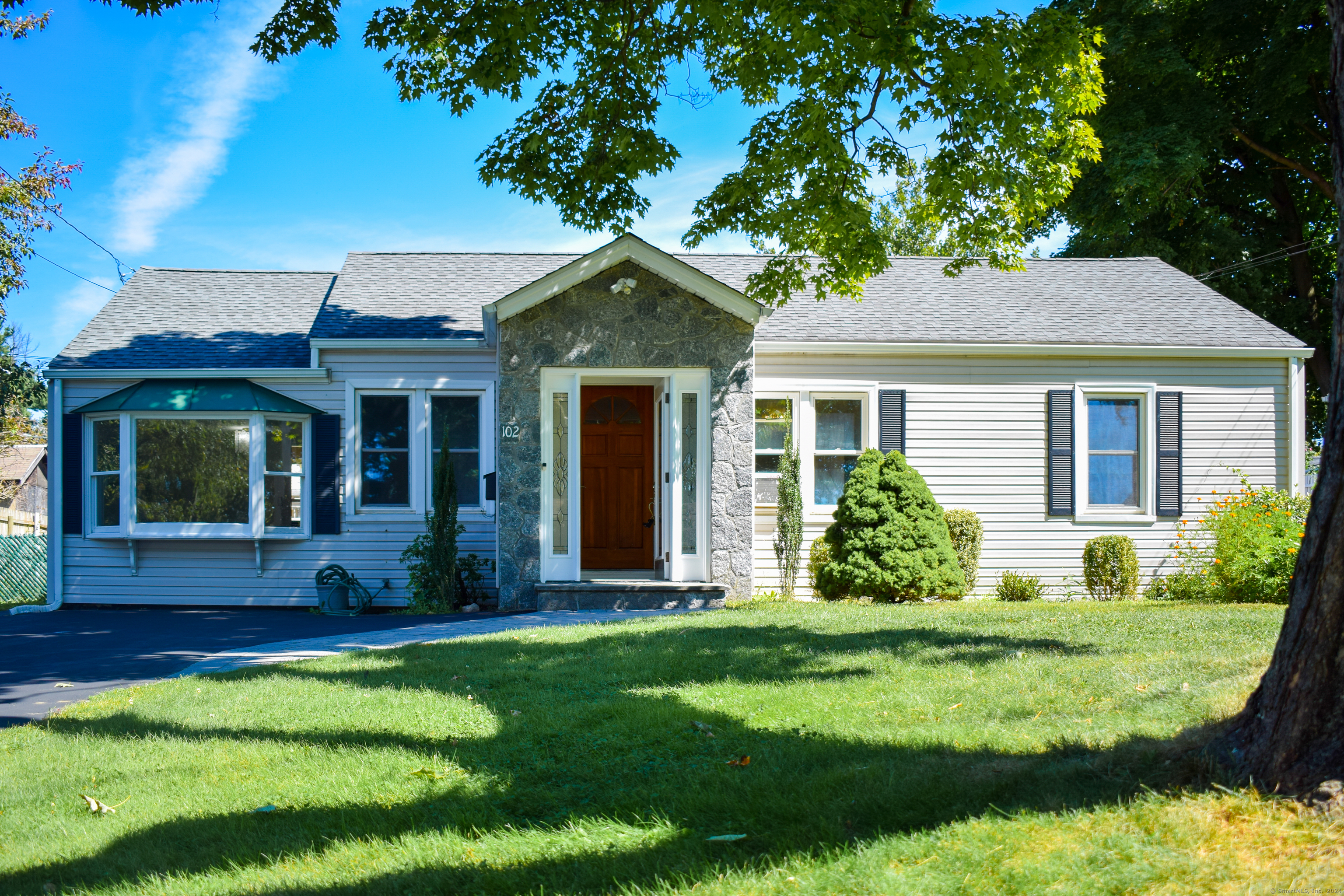 a front view of a house with garden and porch