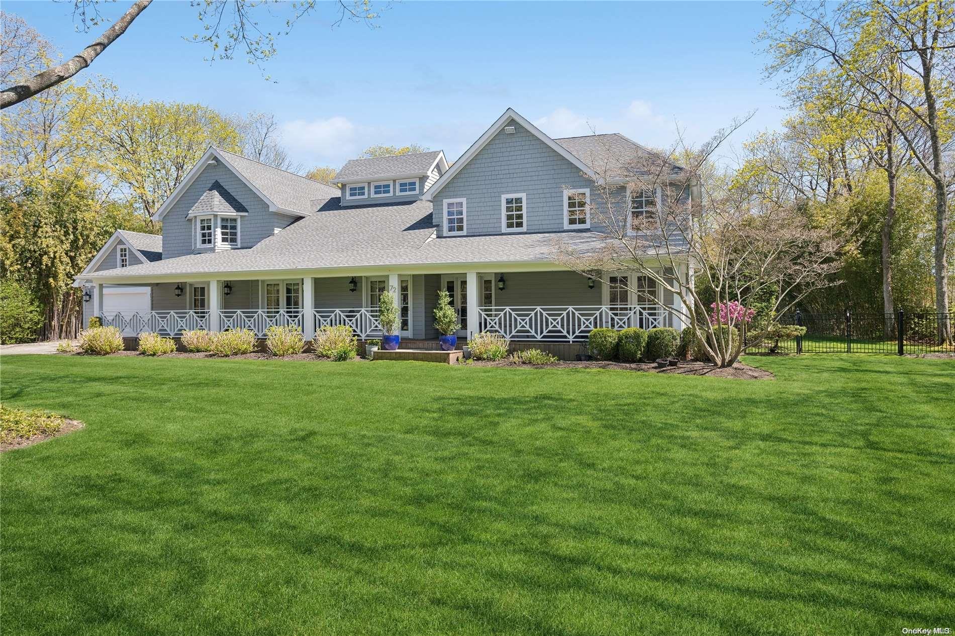 a view of a house with a big yard and large trees