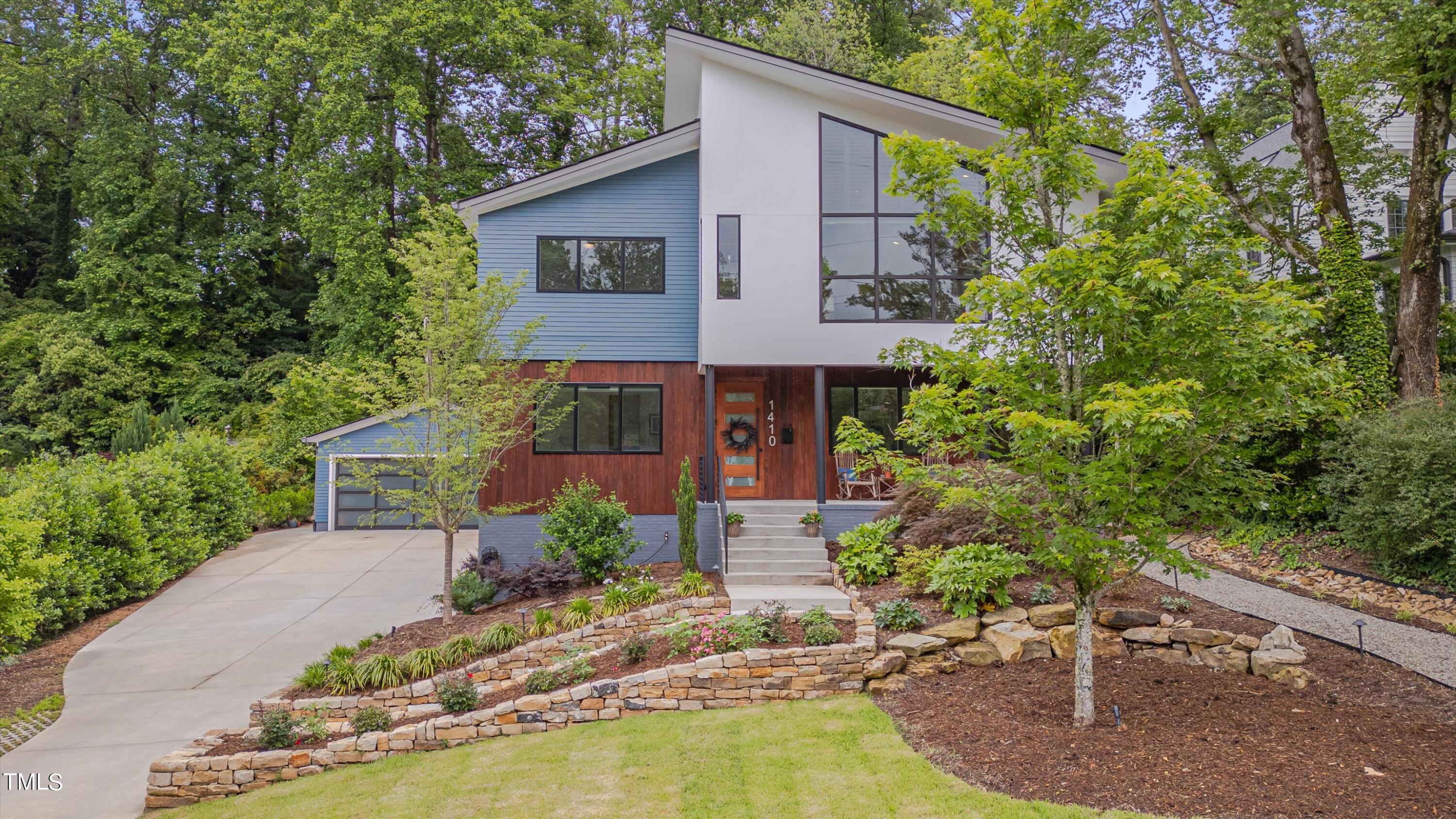 a front view of a house with a yard garage and outdoor seating