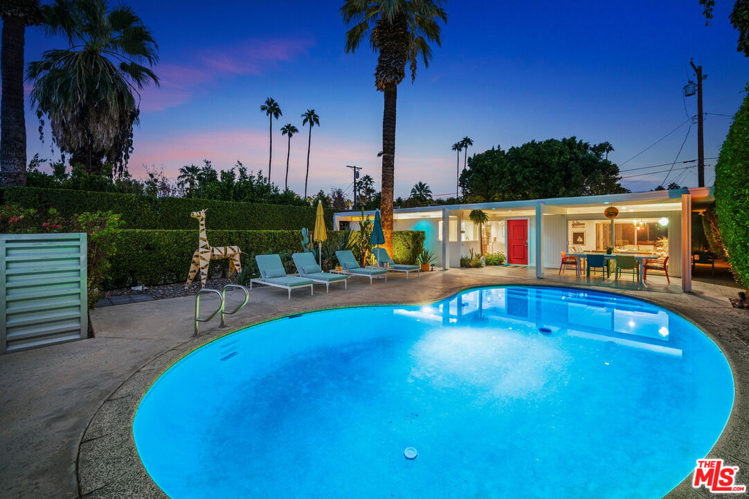 a view of a swimming pool with a table and chairs