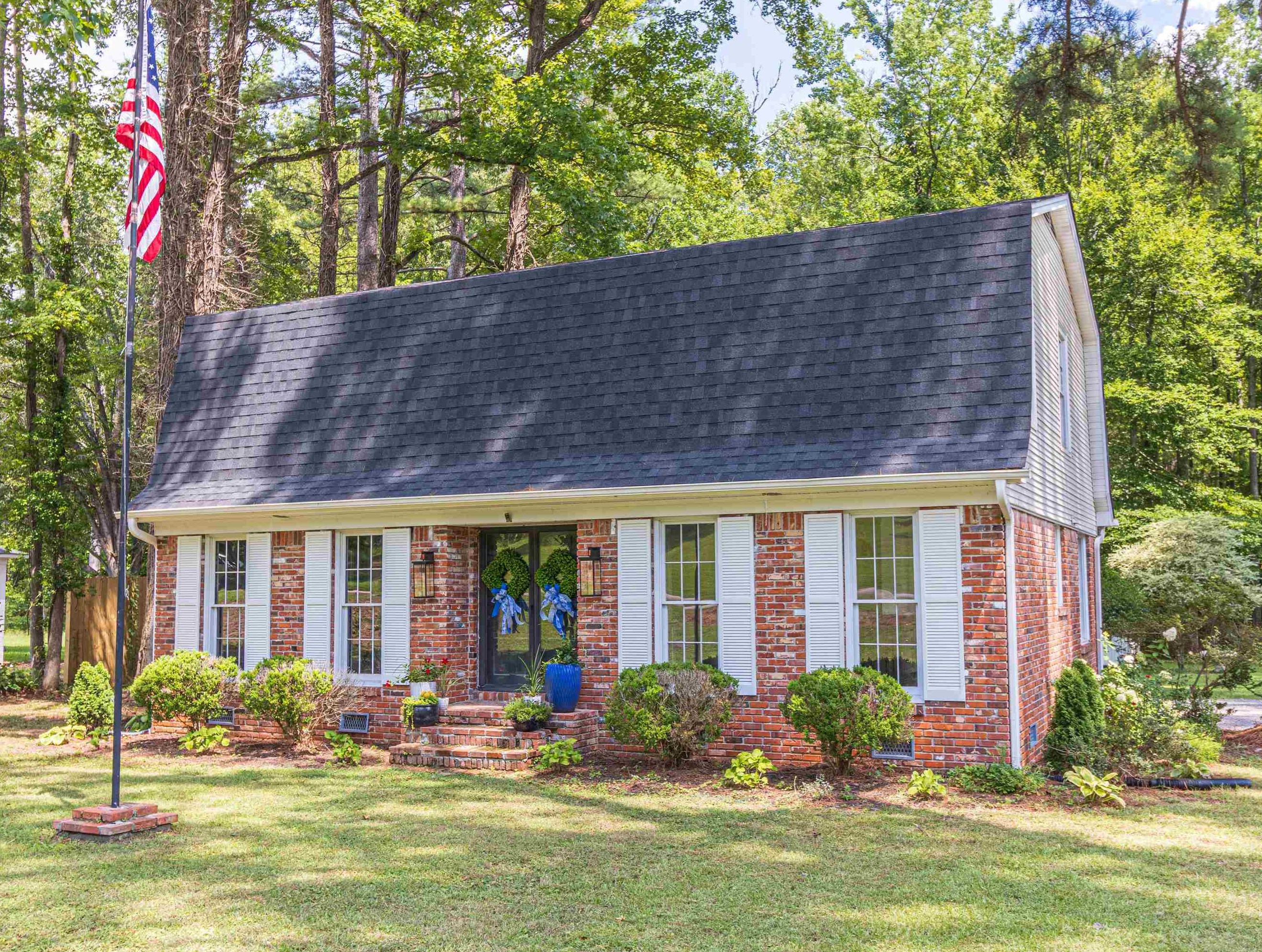 a front view of house with yard and outdoor seating