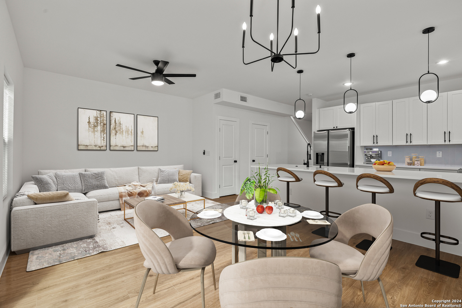 a living room with furniture kitchen view and a chandelier