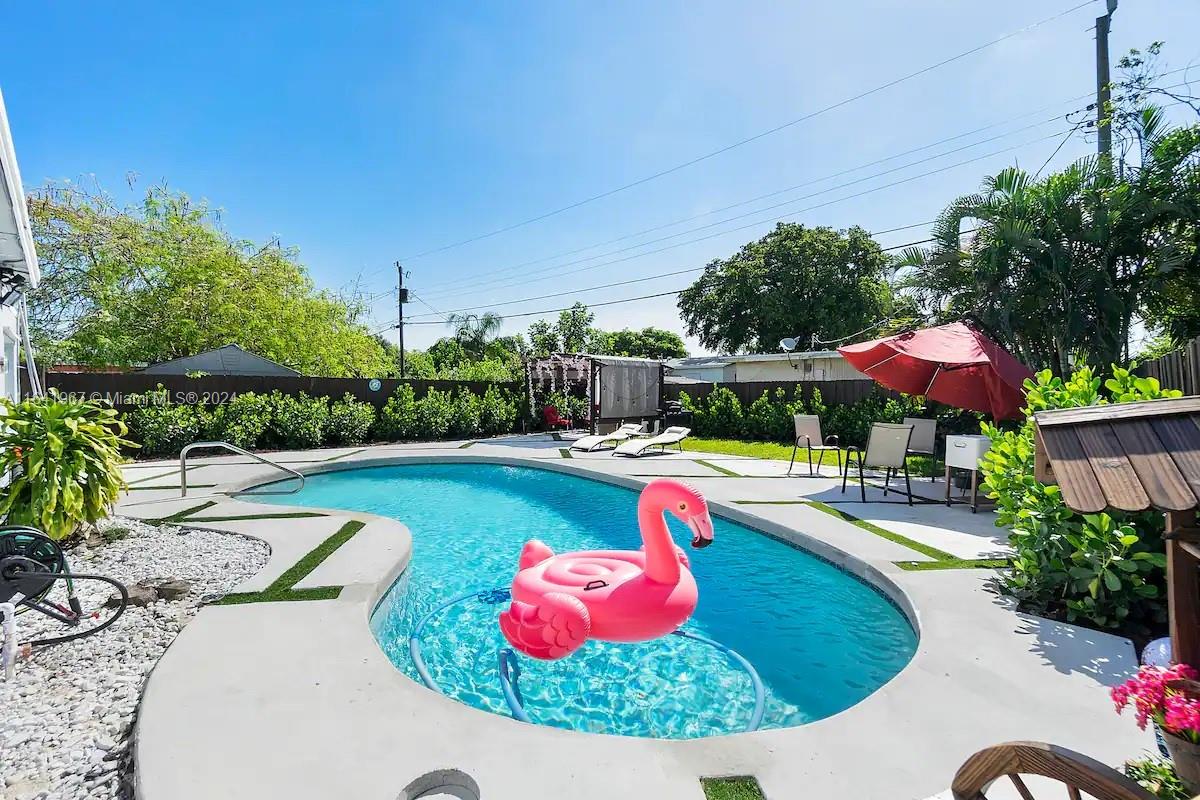 a view of a swimming pool with a yard potted plants