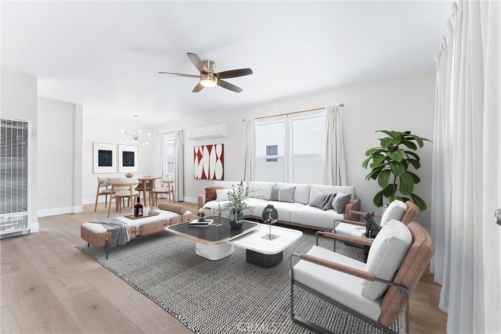 a living room with furniture and a potted plant