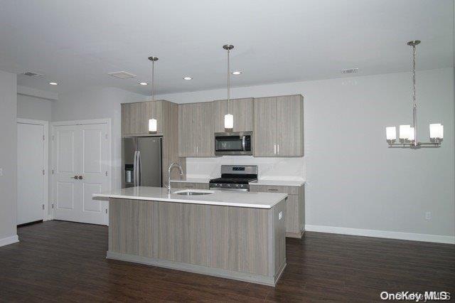 a kitchen with kitchen island white cabinets and stainless steel appliances