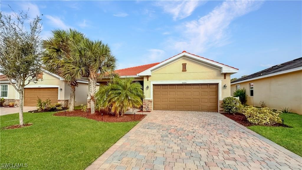 a front view of a house with a yard and garage