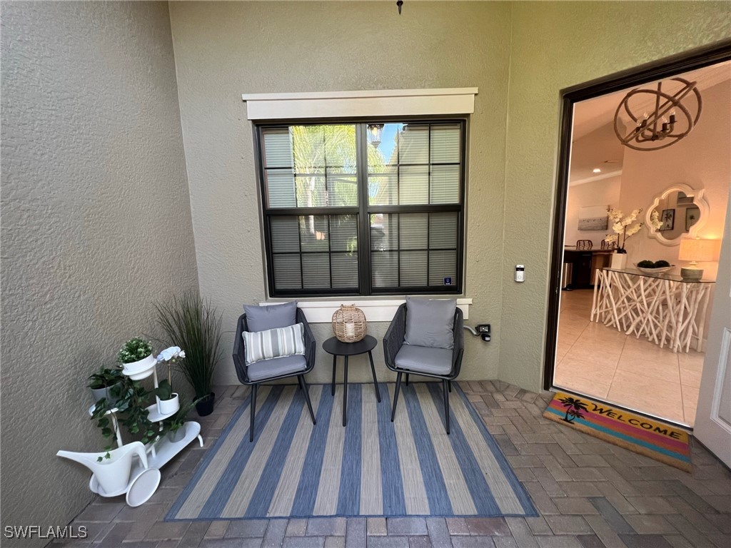 a balcony with wooden floor and a potted plant