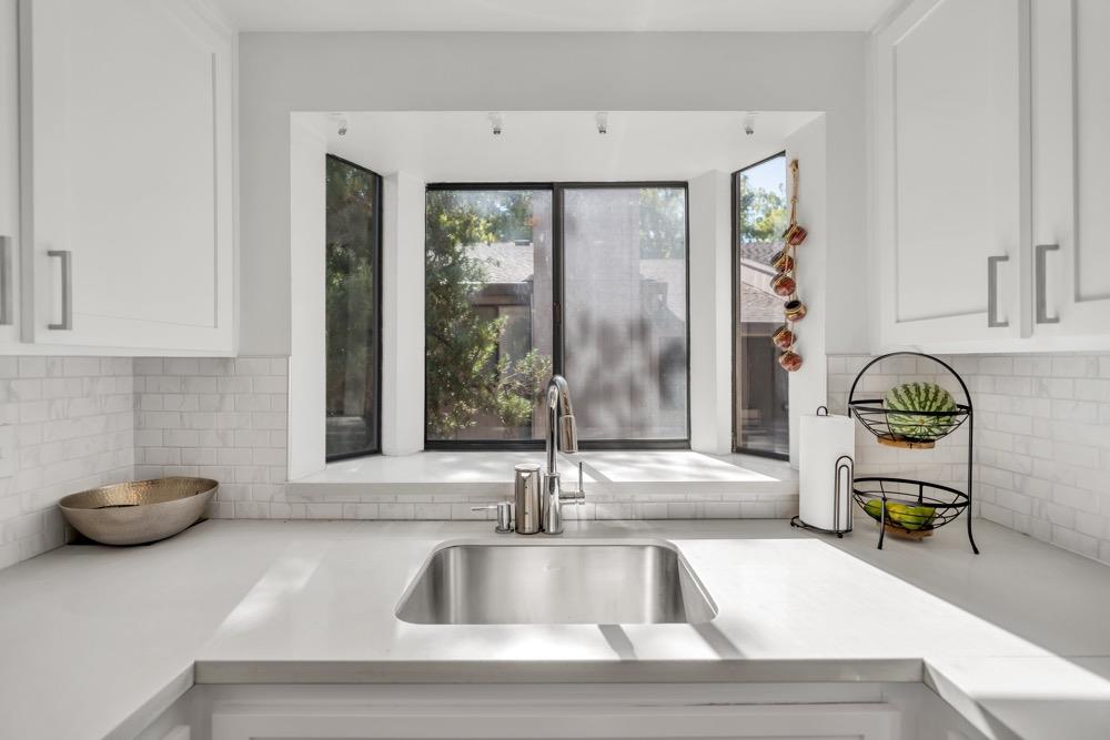 a kitchen with a sink and a window